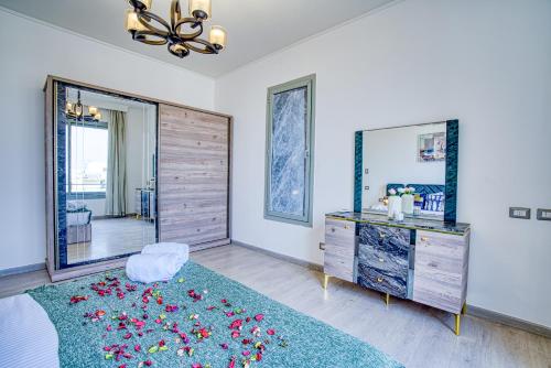 a bedroom with a large mirror and a dresser at The Suites near AUC by Elegant Hospitality in Cairo