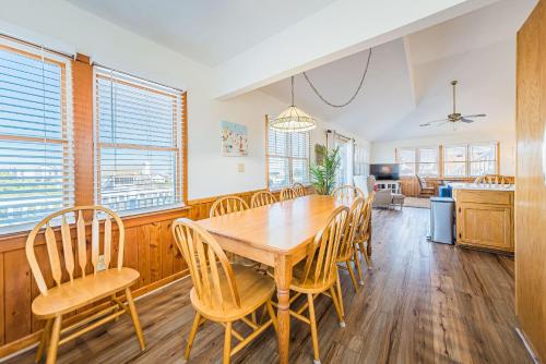 a dining room with a wooden table and chairs at Sound Waves in Duck