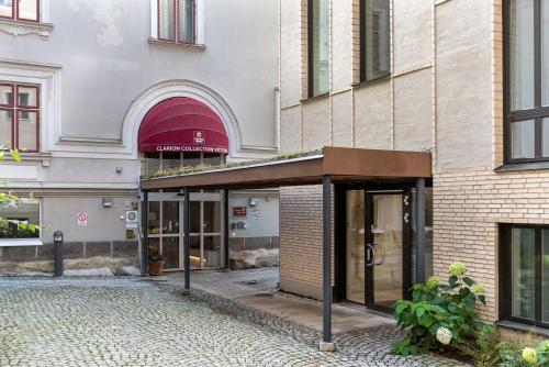 a building with awning in front of a building at Home Hotel Victoria in Jönköping
