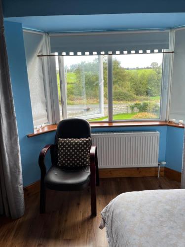 a room with a chair in front of a window at Doughlasha House V93RX64 in Killarney
