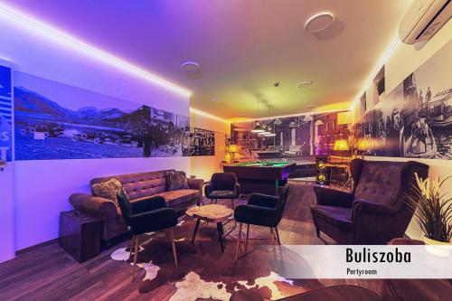 a living room with a couch and chairs and a table at Mártoni Resort & Restaurant in Szigetszentmárton