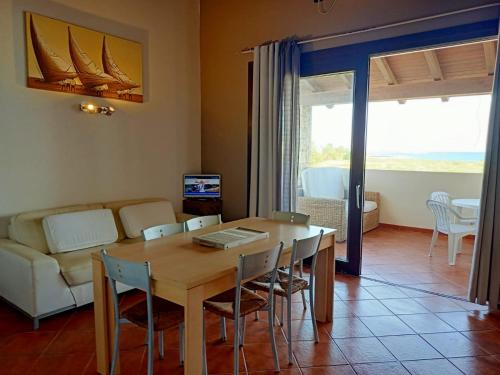 a living room with a table and chairs and a couch at Sal&Love apt in Porto Antigo in Santa Maria