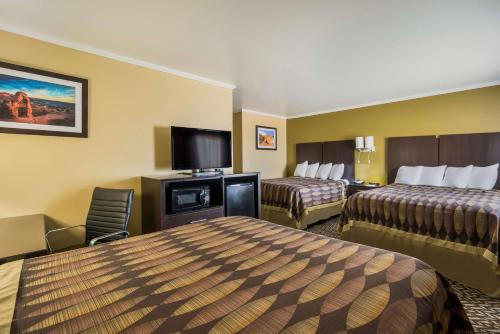 a hotel room with two beds and a flat screen tv at Best Western Richfield Inn in Richfield