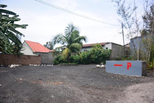 a parking lot with a red p sign in front of a house at Isange Paradise Resort in Ruhengeri