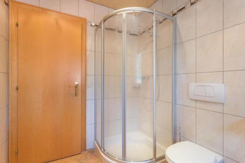 a shower stall with a toilet in a bathroom at Ferienwohnung Hörbiger in Wildschönau