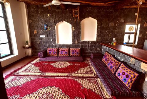 a living room with a couch and a rug at ROSES HOUSE OMAN 2 in Al ‘Aqar