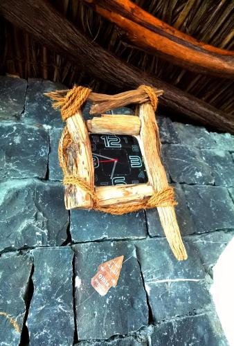 a clock on top of a stone wall at ROSES HOUSE OMAN 2 in Al ‘Aqar