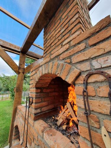 a brick oven with a fire in it at Magic Rooms in Gura Teghii
