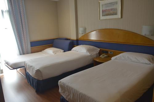 a hotel room with two beds and a window at Agumar in Madrid