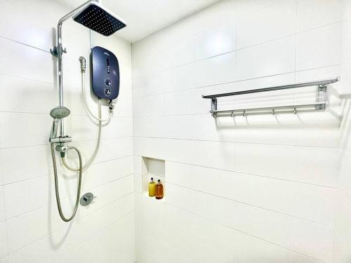 a shower with a shower head in a bathroom at E 1-5Pax Cozy home 4 Bed Wifi TV Trefoil @Setia City Setia Alam SCCC in Setia Alam