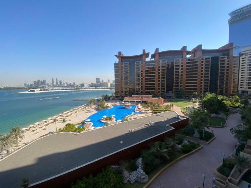 a view of a resort with a beach and buildings at Tiara Emerald - 1BR Apartment - Allsopp&Allsopp in Dubai