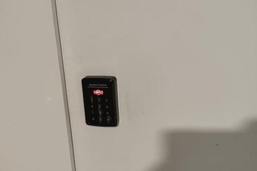 a close up of a white refrigerator with a black button at Midtown Hotel Apartments 301 (2+1) in Istanbul