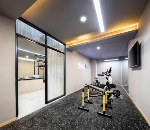 a gym with a treadmill and a bike in a room at Atour Hotel Tongliao Wanda Plaza in Tongliao