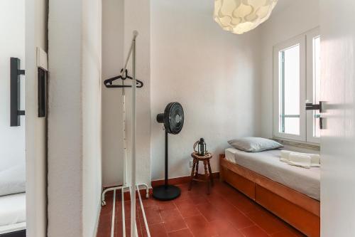 a small bedroom with a bed and a window at Vita Portucale ! Costa Caparica Triplex w/ Terrace in Costa da Caparica