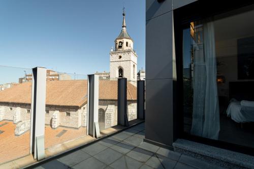 a balcony with a view of a church tower at Edificio Santiago by Plaza Mayor Apartamentos in Valladolid