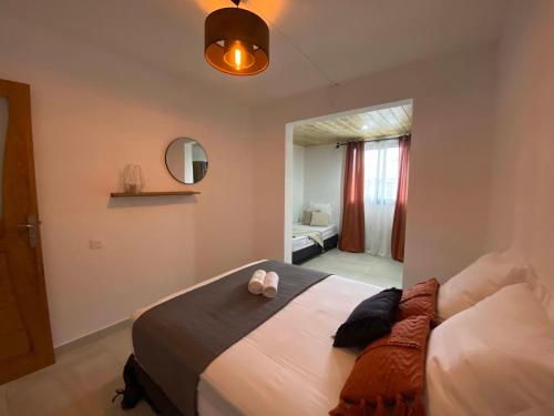 a bedroom with a large bed and a bathroom at Villa Horizon in Saint-Joseph