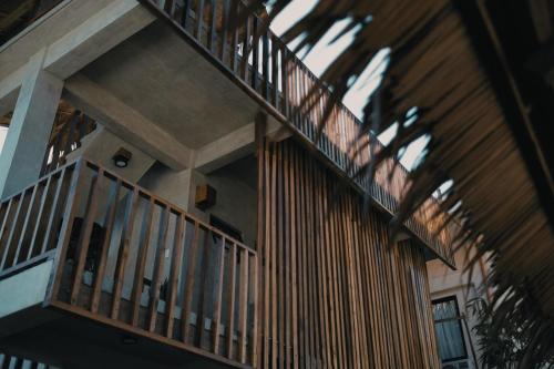 a building with a wooden staircase with a balcony at Diwa Siargao Eco-House in General Luna