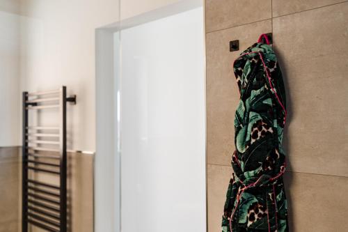 a blanket hanging on a wall next to a door at Sommers "Schöne Aussicht", Adults only in Reichenbach im Vogtland