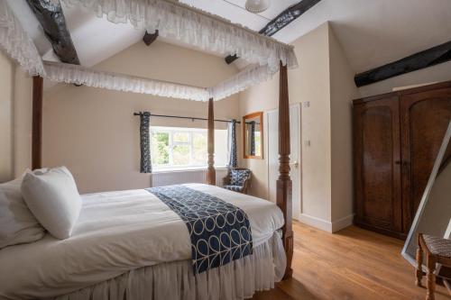 a bedroom with a large bed and a window at Little Cowarne Court in Little Cowarne