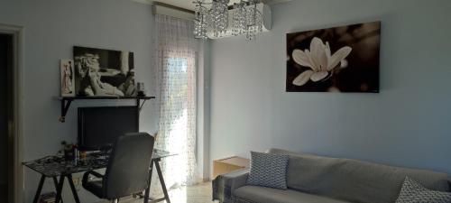 - un salon avec un canapé, une table et un lustre dans l'établissement Maria's home, à Órmos