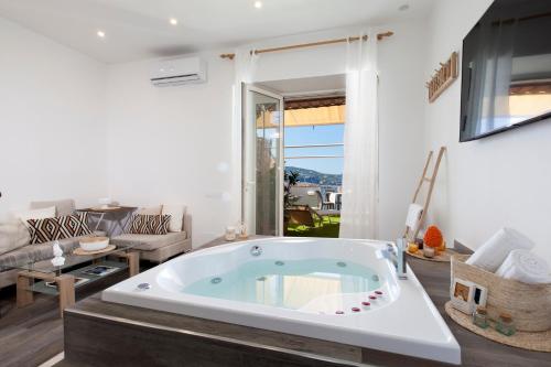 a large bath tub in a room with a living room at Dreamers' Escape in Vico Equense