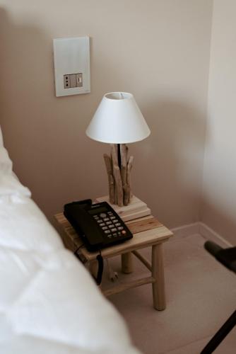 Un ou plusieurs lits dans un hébergement de l'établissement Le Carasse Boutique Hotel