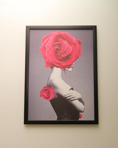 a picture of a woman with a rose on her head at Lộc Thiên Ân hotel in Bien Hoa