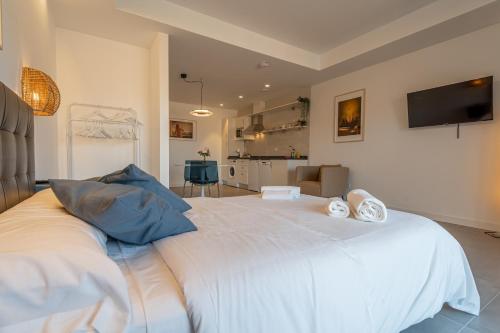 a large white bed with two pillows on top of it at Edificio Santiago by Plaza Mayor Apartamentos in Valladolid