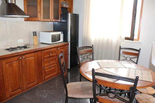 a kitchen with a table and a microwave at Apartment in Batumi in Batumi