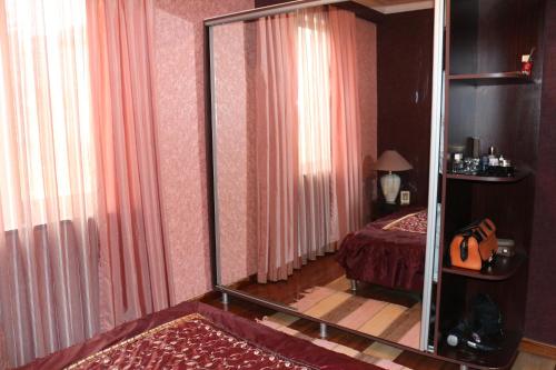 a room with a bedroom with a bed and a mirror at Apartment in Batumi in Batumi