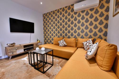 a living room with a couch and a flat screen tv at Villa Diva Grabovčeva in Rakovica