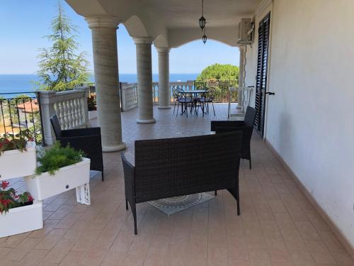 a porch with a table and chairs on a balcony at B&B Rosa dei Venti in Roseto Capo Spulico
