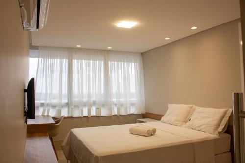 a bedroom with a large bed and a window at Kariris Blue Tower in Crato
