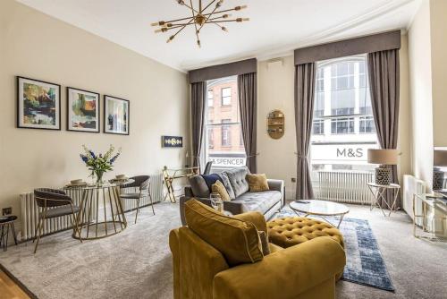 a living room with a couch and a table at Rowntree One - Stunning Apartment- Grade II listed in York
