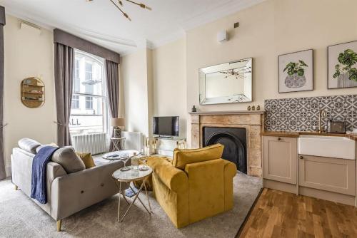 a living room with a couch and a fireplace at Rowntree One - Stunning Apartment- Grade II listed in York