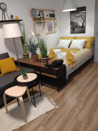 a living room with a couch and a table at Apartman 7th Heaven in Zagreb