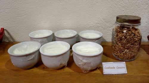 a group of bowls and a jar on a table at Pousada Mareilha in Ilhabela