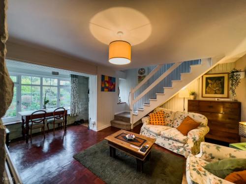 a living room with a couch and a table at Wye Valley near Tintern Abbey Charming cottage within farmhouse Rocklea Farm,Broadstone, Trellech Monmouthshire in Monmouth