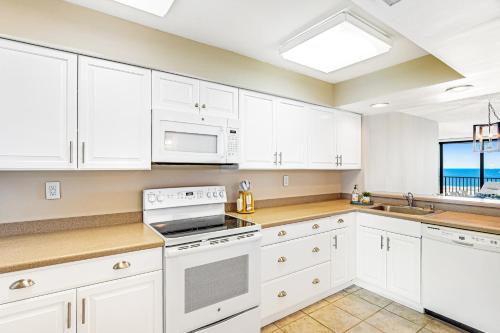 a kitchen with white cabinets and white appliances at Sea Colony - 302S Edgewater in Bethany Beach