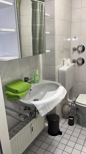 a white bathroom with a sink and a toilet at Good living in Schwetzingen