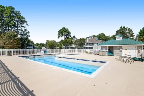 a swimming pool at a apartment complex with a building at Sea Colony - 302S Edgewater in Bethany Beach