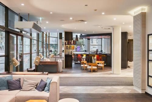 a lobby of a building with a couch and chairs at Holiday Inn Vilnius, an IHG Hotel in Vilnius