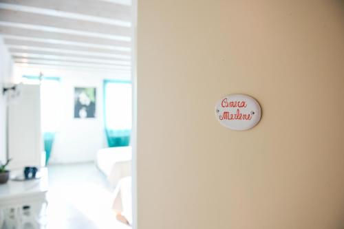 a white door with a sign that reads gamedev childhood at Le Rêve - Lake view rooms in Sirmione