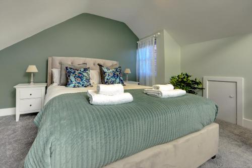 a large bed with two pillows on it in a bedroom at The Nook - A modern 2 bedroom loft with parking in Ripon