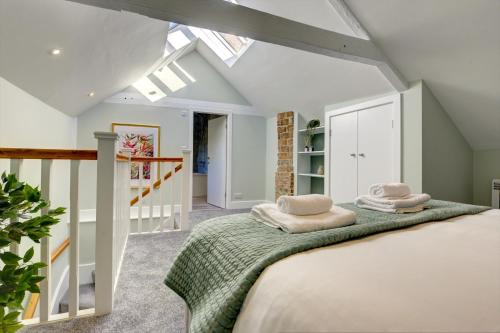 a bedroom with a bed with two pillows on it at The Nook - A modern 2 bedroom loft with parking in Ripon