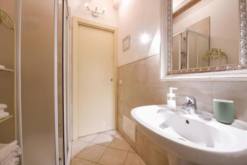 a bathroom with a sink and a mirror at Le Rêve - Lake view rooms in Sirmione