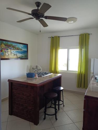 a kitchen with a counter and a ceiling fan at Holiday Home Belvedere in Dickenson Bay