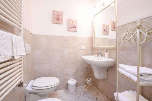 a bathroom with a toilet and a sink and a mirror at Le Rêve - Lake view rooms in Sirmione