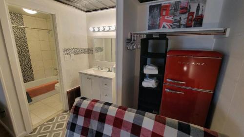 a bathroom with a red refrigerator and a sink at Sussex Motel in Wantage