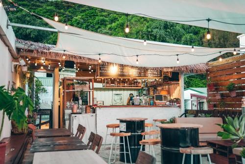 a bar with wooden tables and chairs and lights at Juran B&B in Nanwan